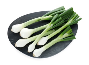Photo of Board with green spring onions isolated on white, top view
