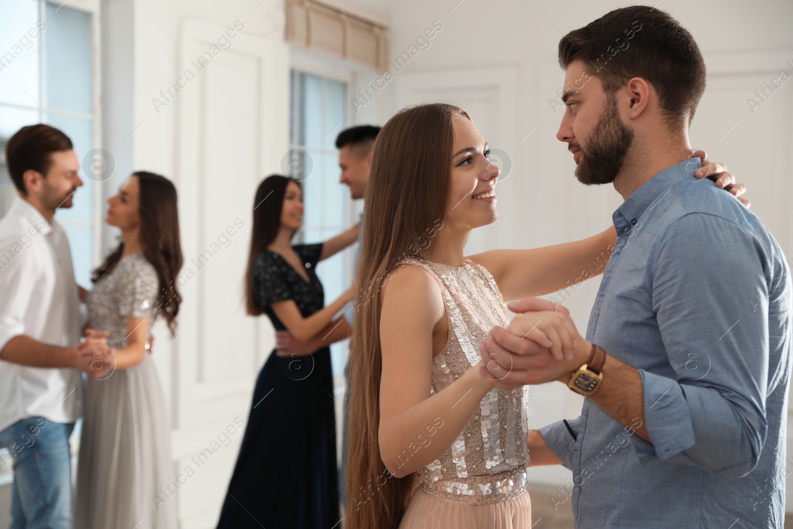 Photo of Lovely young couple dancing together at party