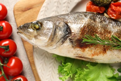 Photo of Delicious baked fish and vegetables on table, top view