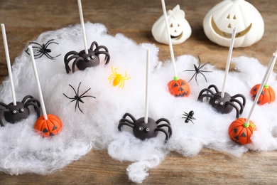 Photo of Different Halloween themed cake pops on wooden table