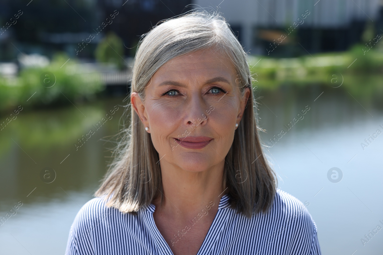 Photo of Portrait of beautiful smiling senior woman outdoors