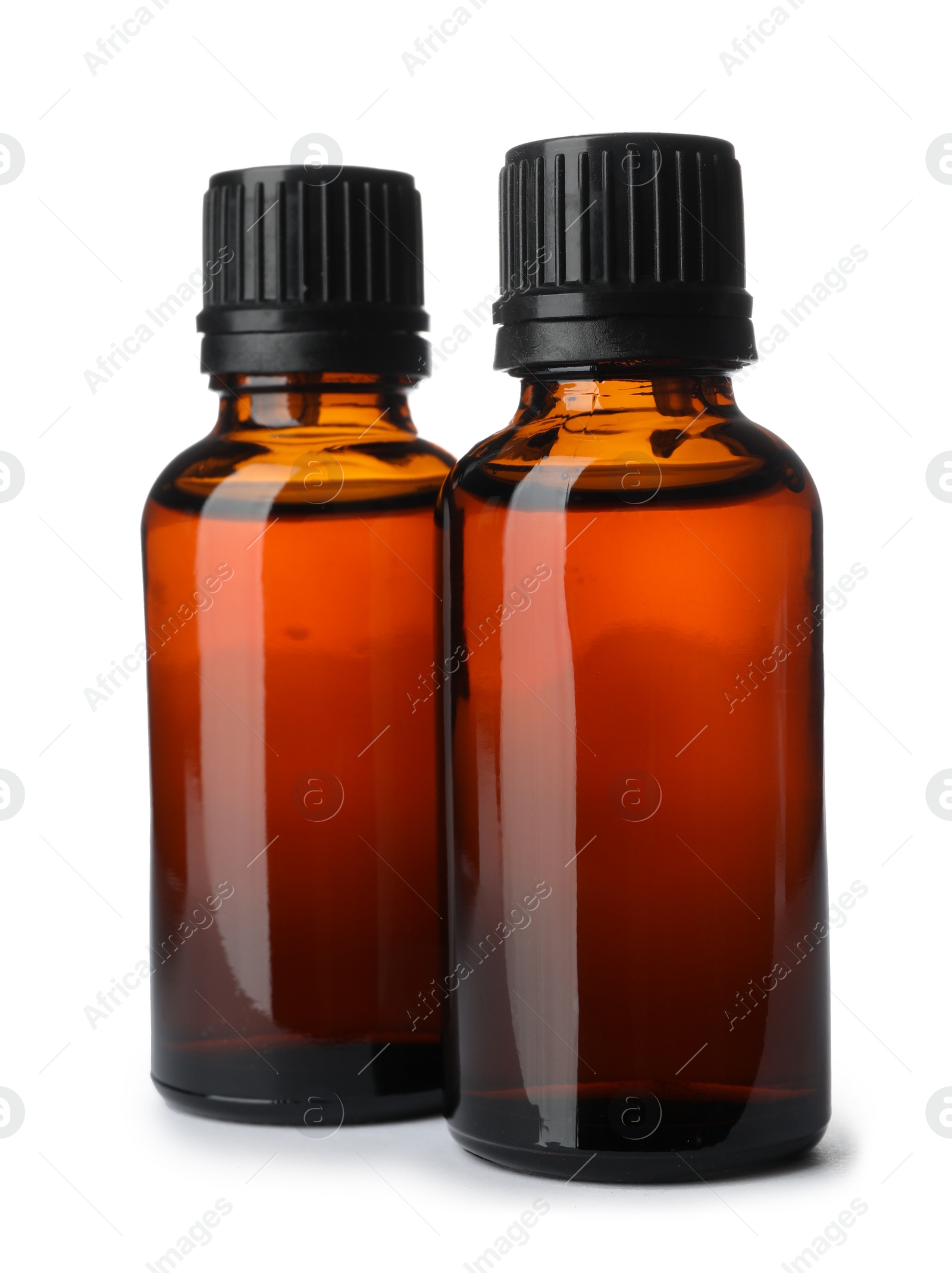 Photo of Bottles of essential oil isolated on white