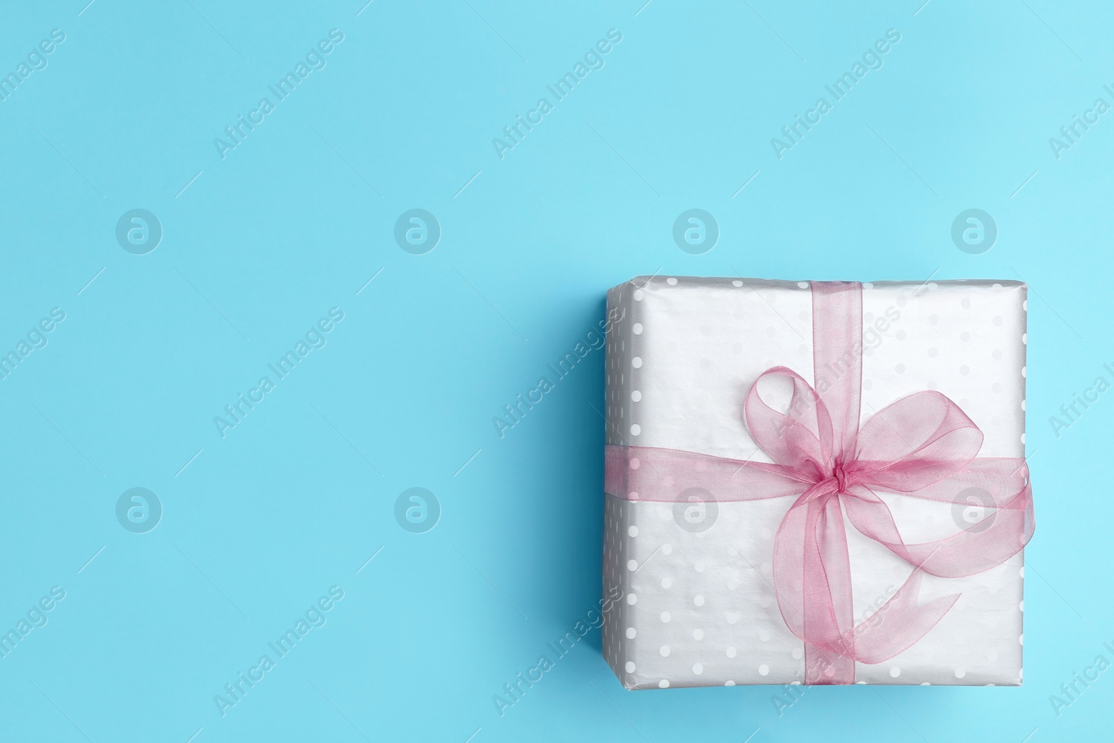 Photo of Beautifully decorated gift box on color background, top view