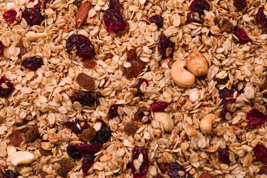 Photo of Sweet tasty granola as background, top view