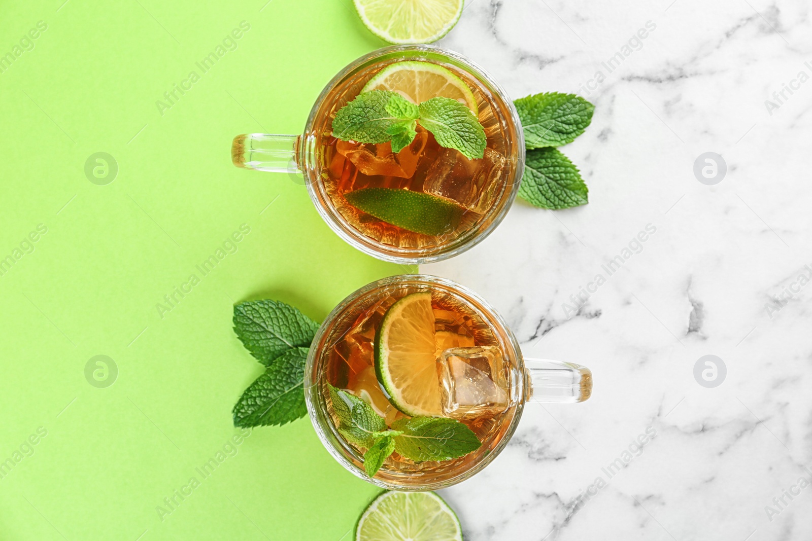 Photo of Flat lay composition with refreshing iced tea on table