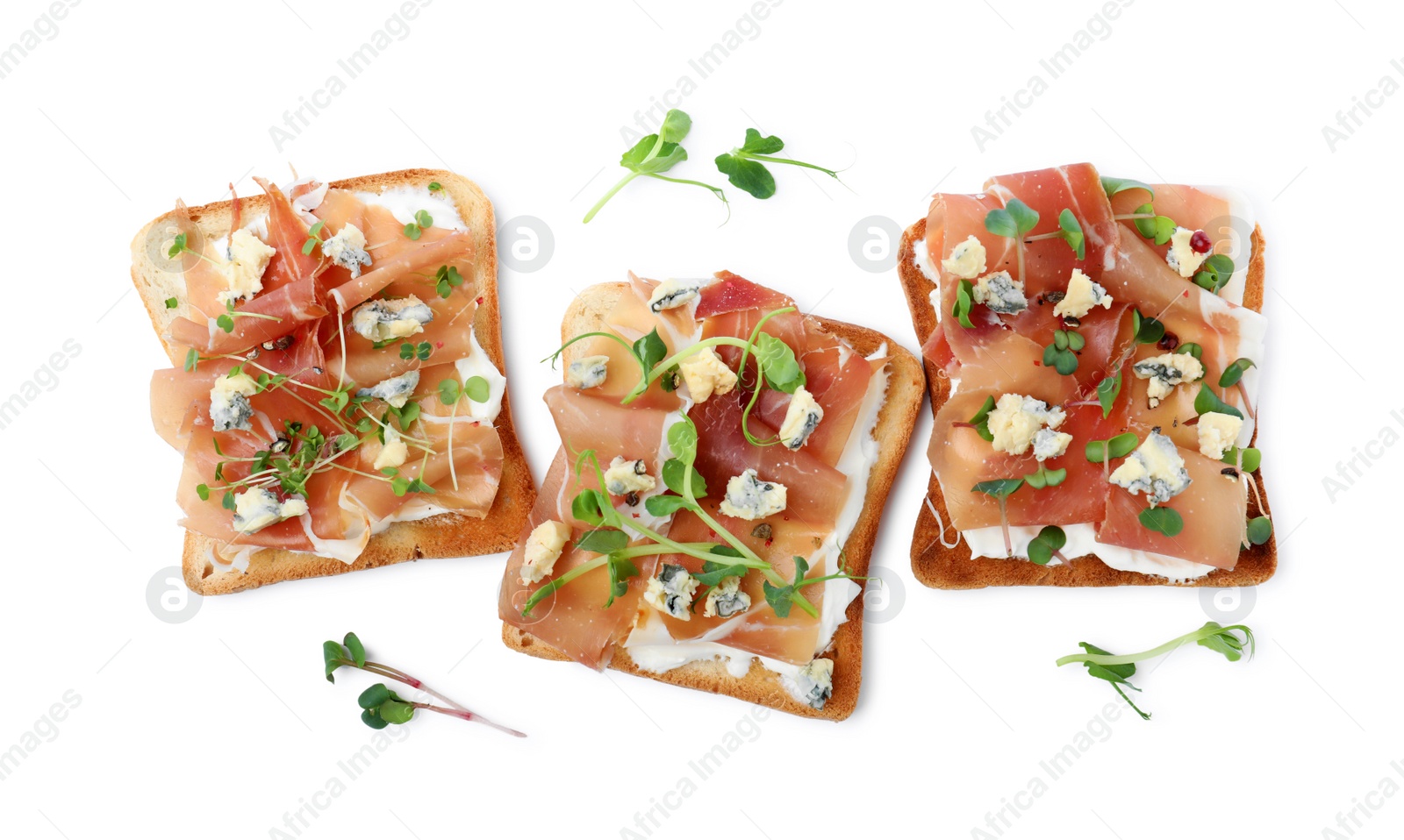 Photo of Delicious sandwiches with prosciutto, microgreens and cheese on white background, top view