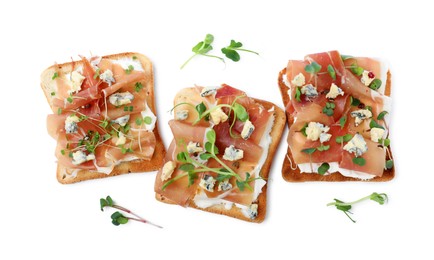 Photo of Delicious sandwiches with prosciutto, microgreens and cheese on white background, top view