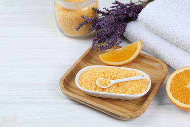 Photo of Sea salt, lavender, orange and towels on white wooden table. Space for text