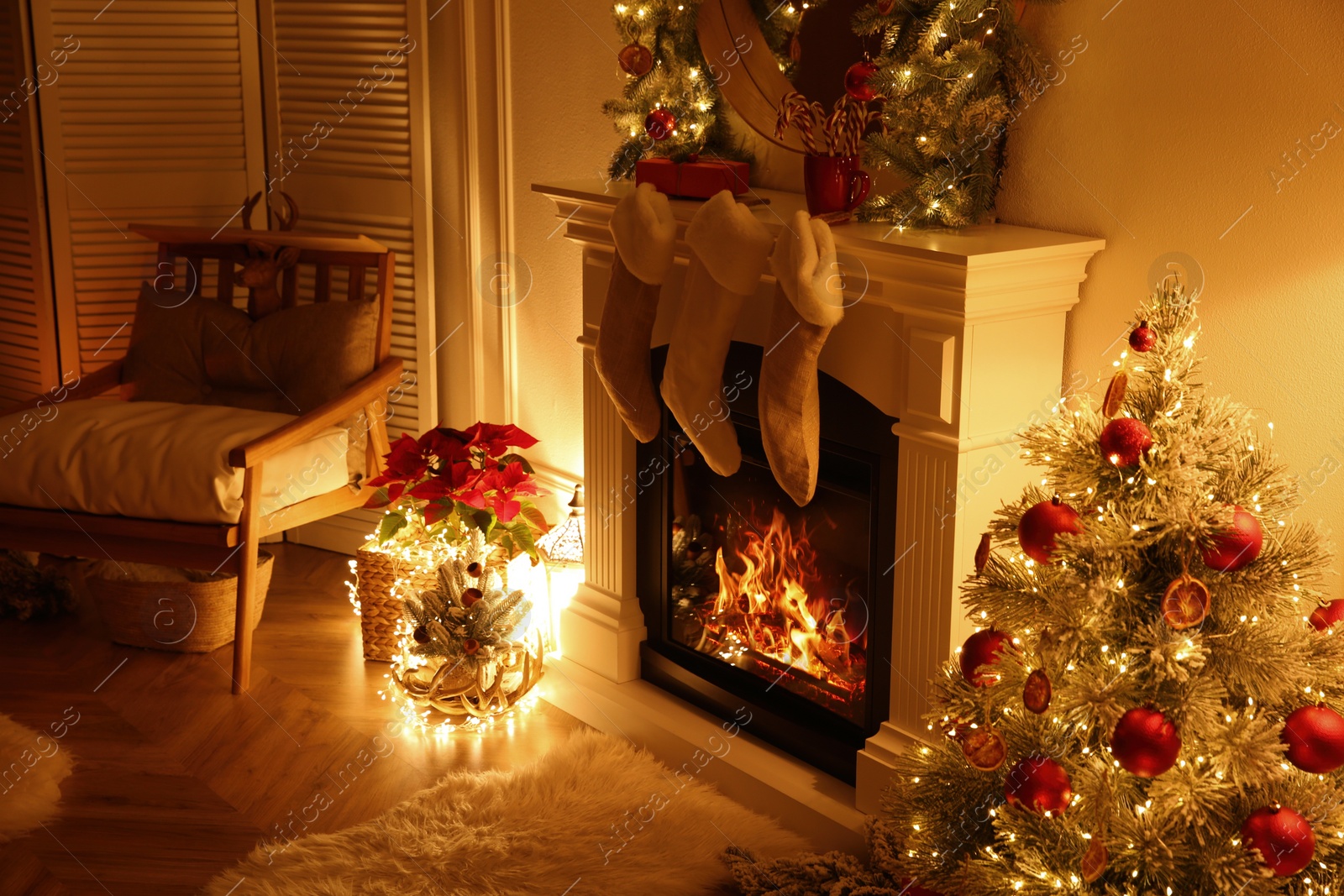 Photo of Fireplace with Christmas stockings in beautifully decorated living room