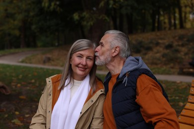 Portrait of affectionate senior couple in autumn park