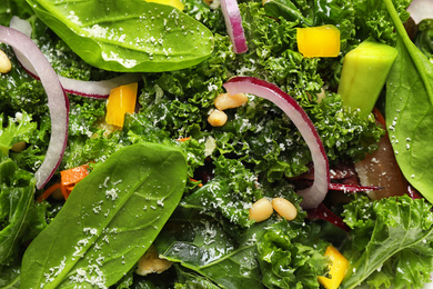 Photo of Tasty fresh kale salad as background, closeup