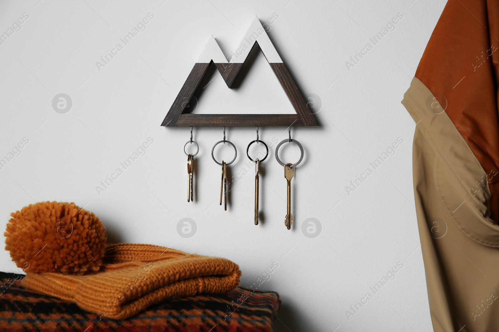 Photo of Wooden key holder on light wall indoors