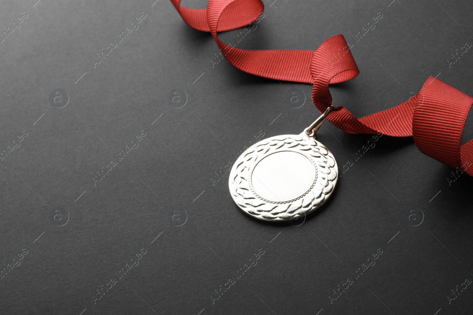 Photo of Gold medal with space for design on black background. Victory concept