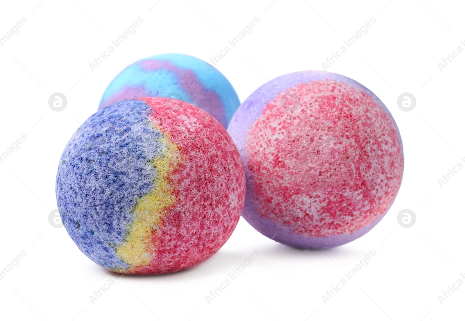 Photo of Three colorful bath bombs on white background