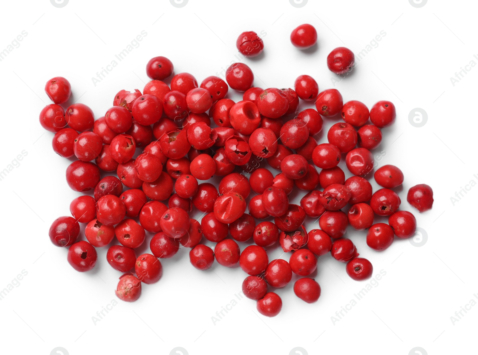 Photo of Aromatic spice. Many red peppercorns isolated on white, top view