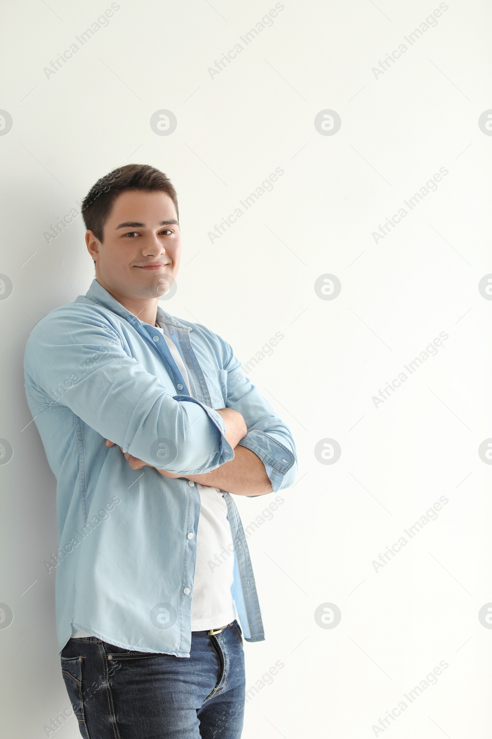 Photo of Portrait of confident young man on light background