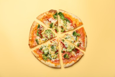 Delicious vegetarian pizza on yellow table, top view