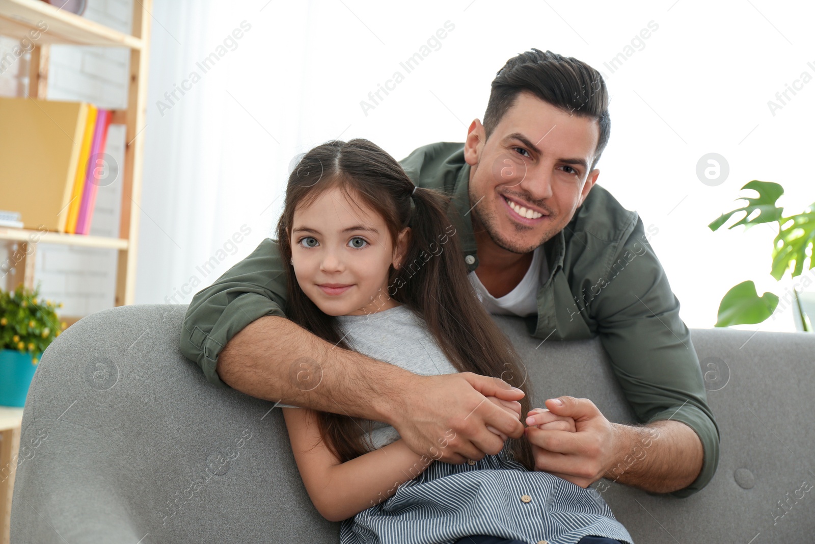 Photo of Dad and daughter spending time together at home. Happy Father's Day