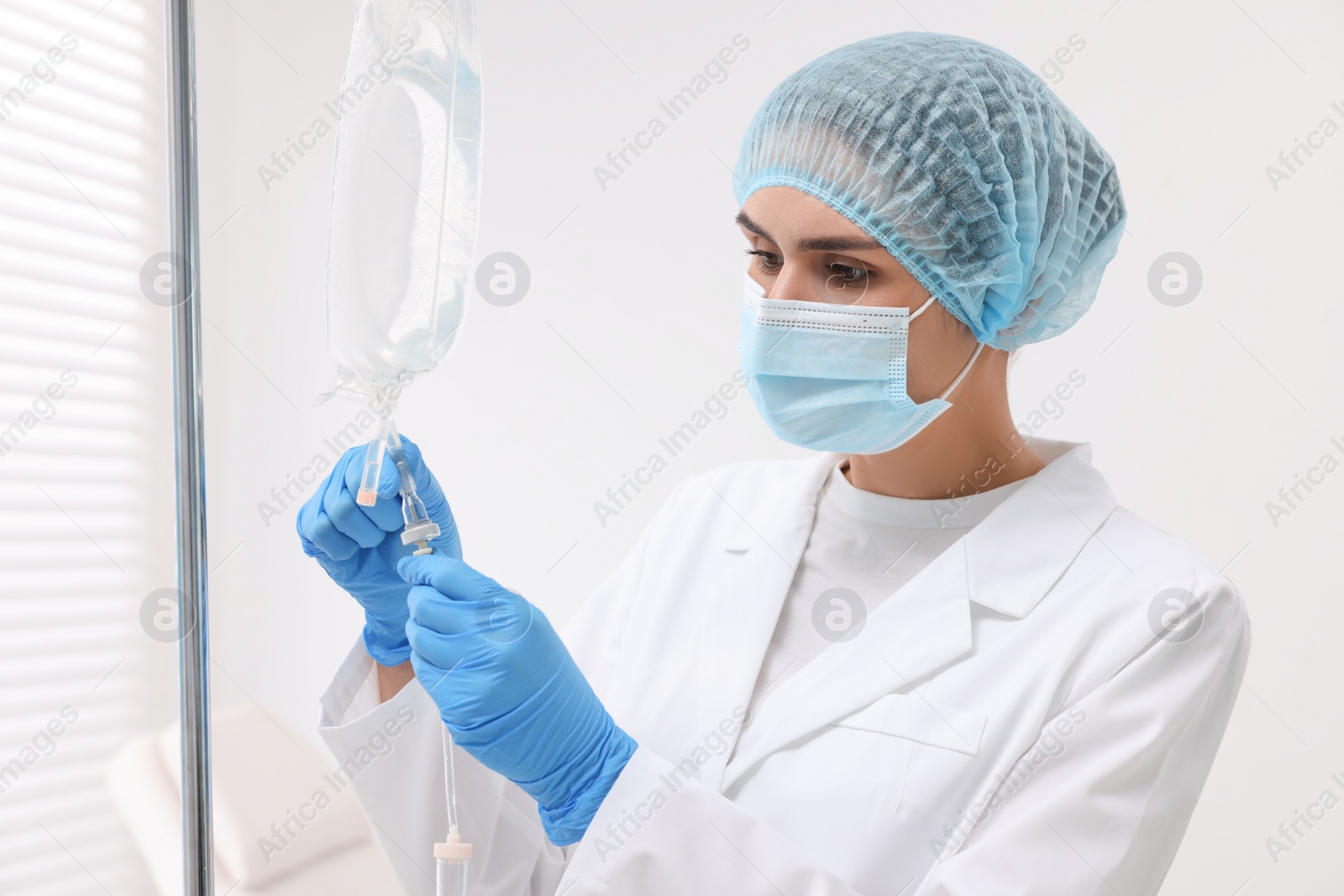 Photo of Nurse setting up IV drip in hospital