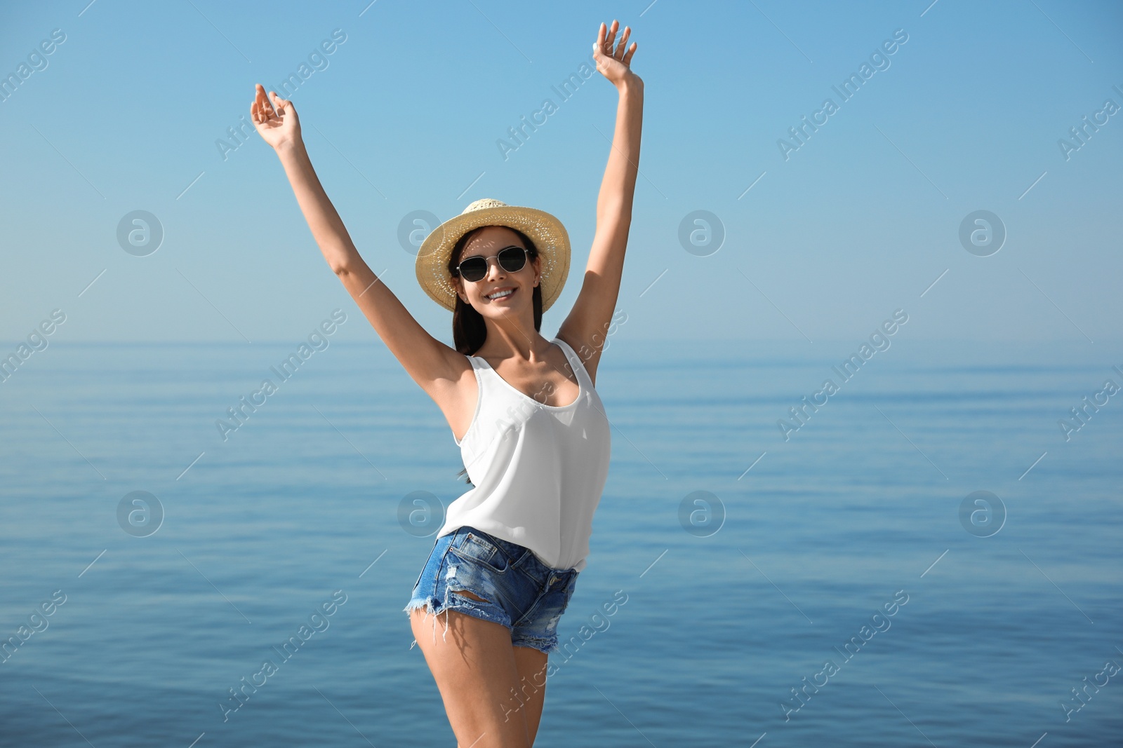 Photo of Beautiful young woman in casual outfit on beach