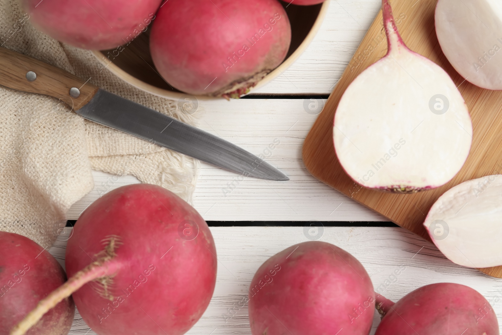 Photo of Raw red turnips on white wooden table, flat lay