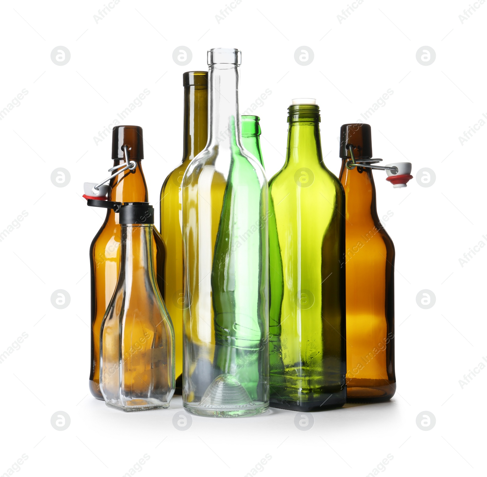 Photo of Empty glass bottles on white background. Recycling problem