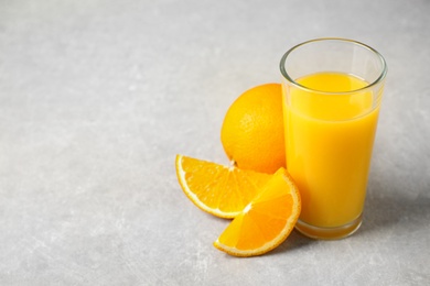 Photo of Freshly made orange juice on light table. Space for text