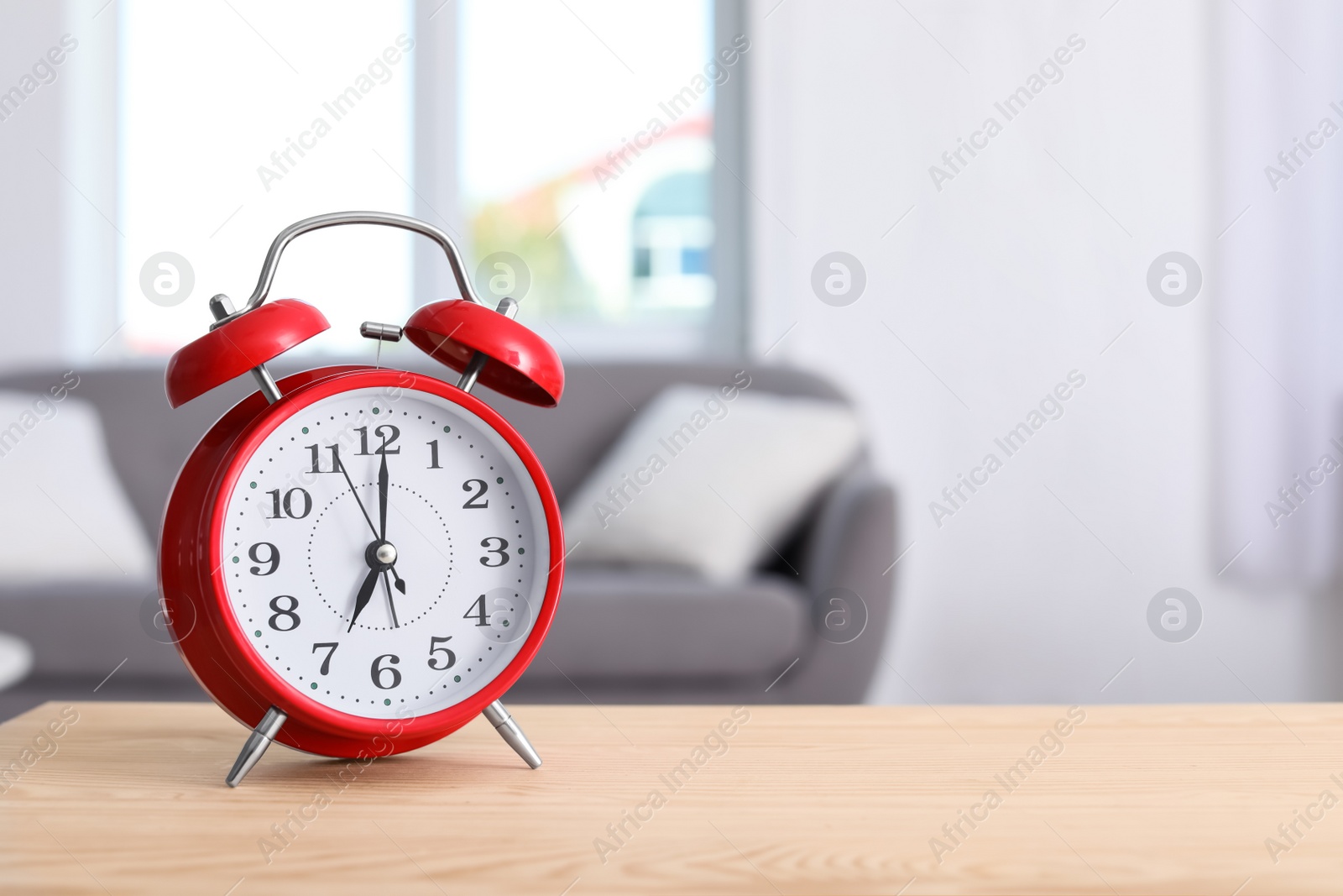 Photo of Alarm clock on table in living room. Time of day