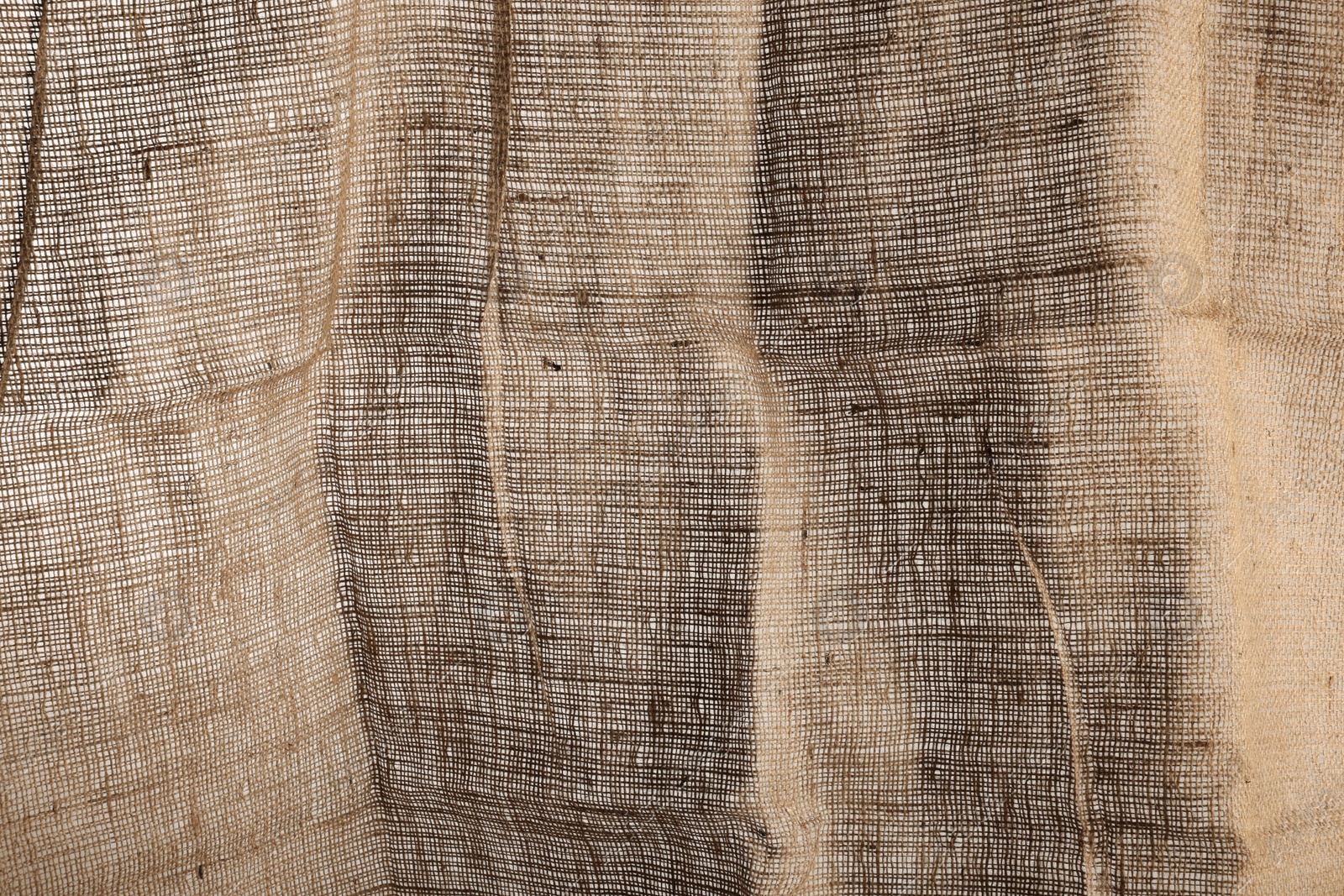 Photo of Texture of natural burlap fabric as background, closeup