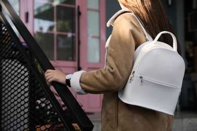 Photo of Woman with stylish white backpack on city street, closeup