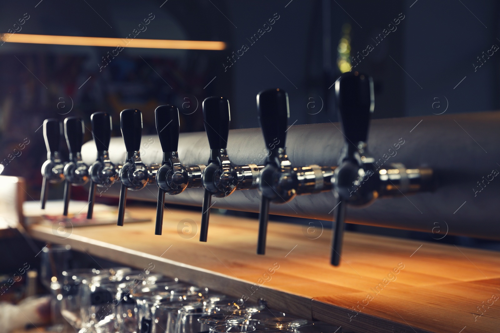 Photo of Row of shiny beer taps in pub