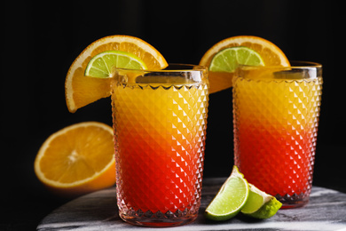 Photo of Fresh alcoholic Tequila Sunrise cocktails on marble board