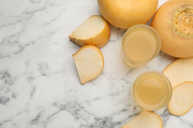 Freshly made turnip juice on white marble table, flat lay. Space for text