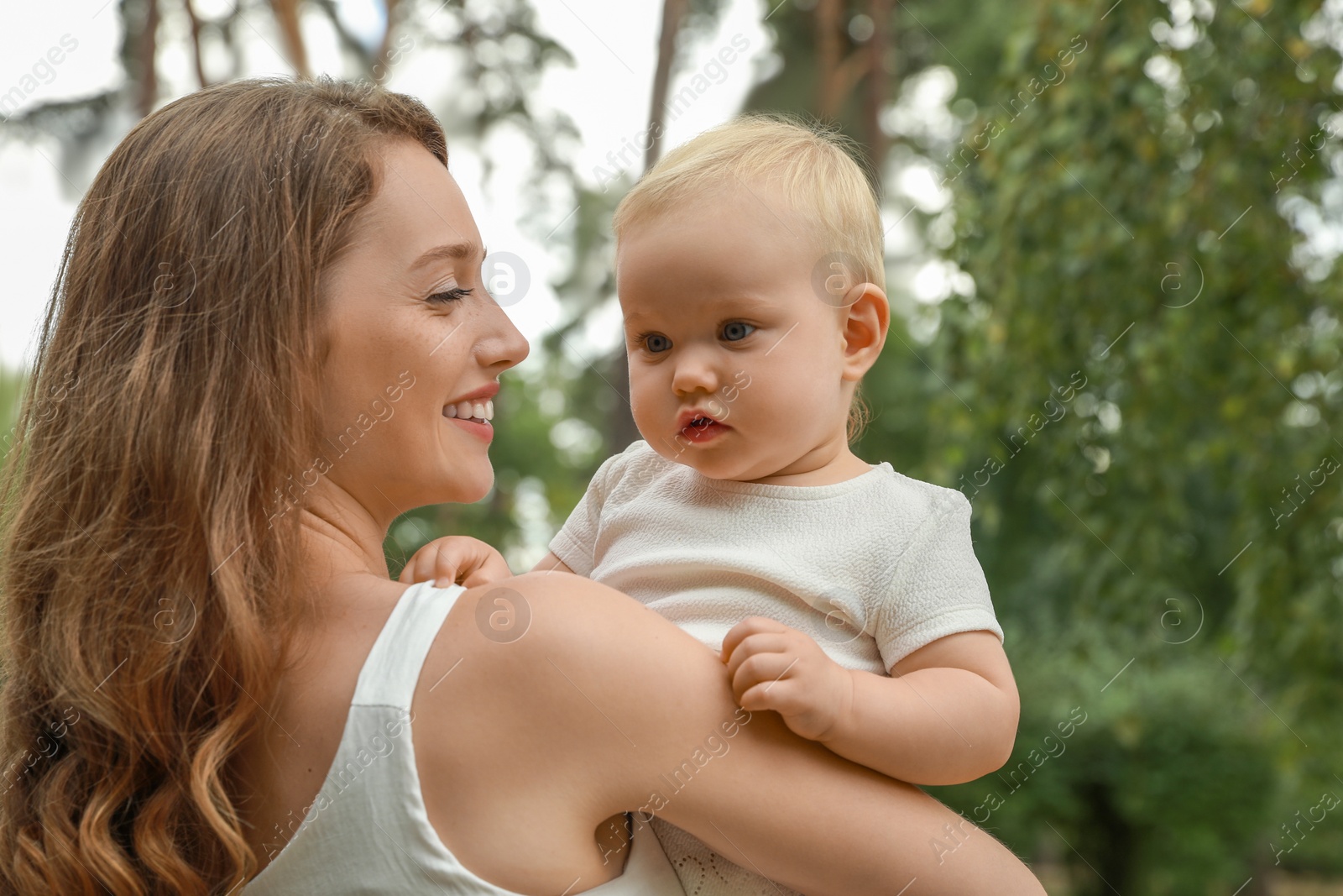 Photo of Mother with her cute baby spending time together outdoors