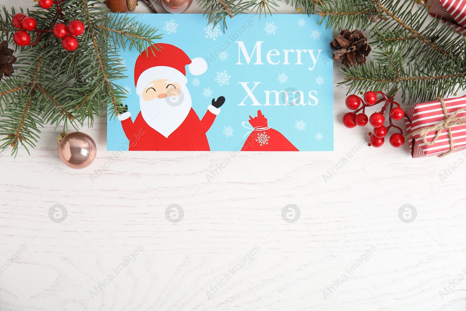 Photo of Flat lay composition with Christmas card and festive decor on white wooden background, space for text