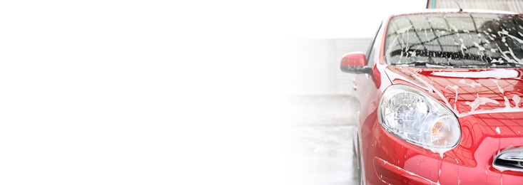 Image of Red auto with foam at car wash, space for text. Banner design