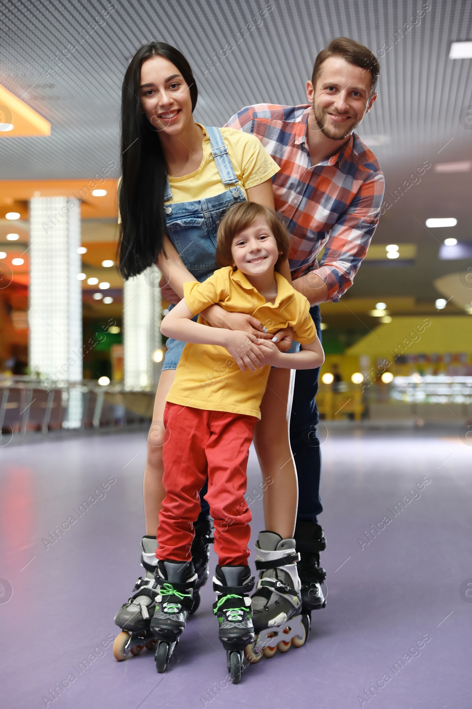 Photo of Happy family spending time at roller skating rink