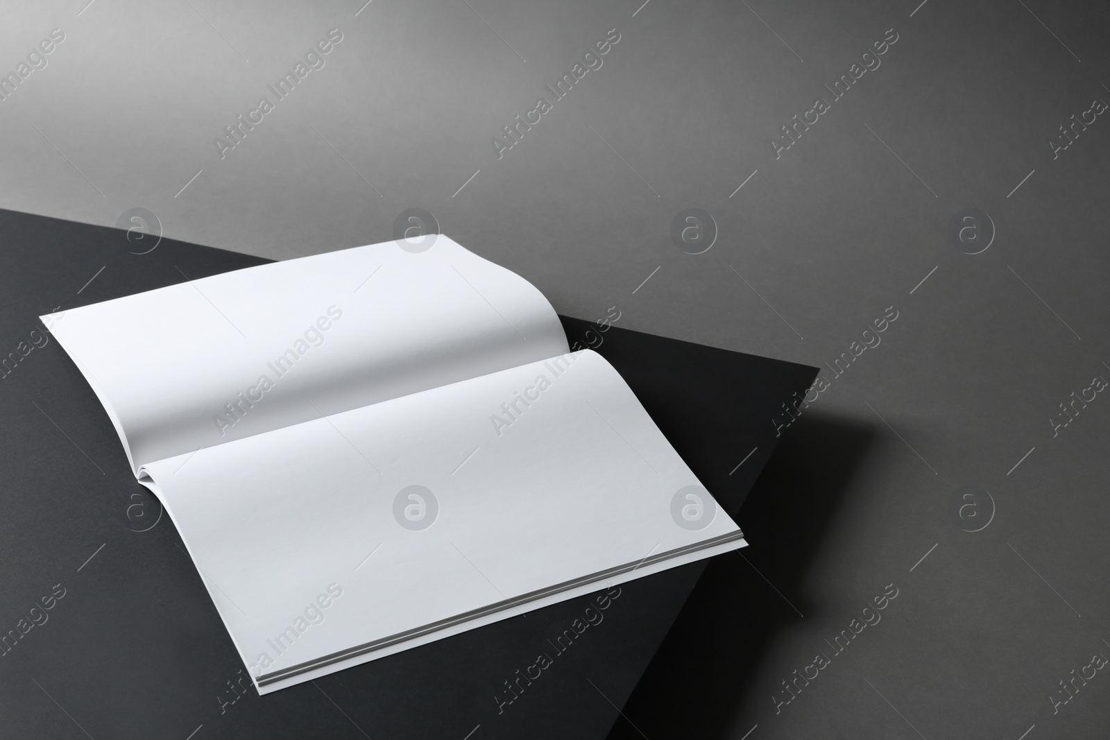 Photo of Empty book pages on dark background. Mockup for design