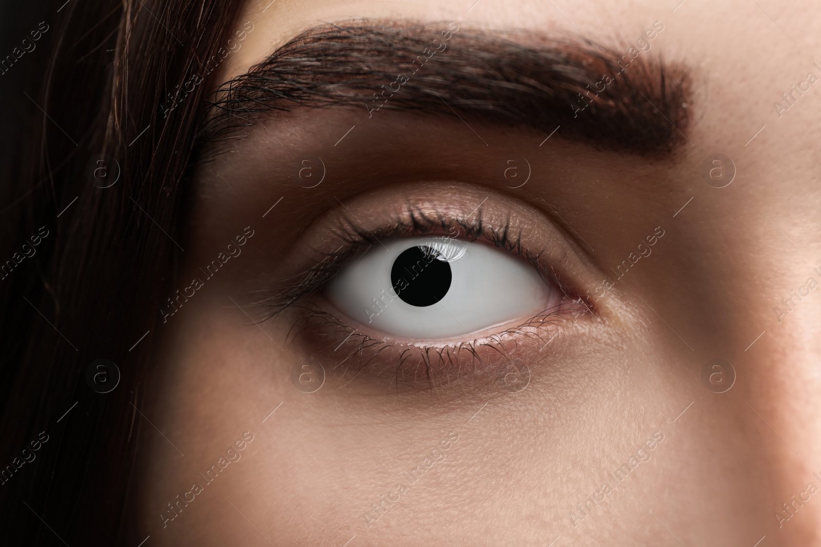 Photo of Mysterious witch with spooky eyes, closeup. Halloween party