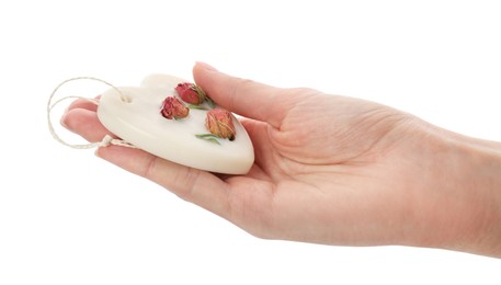 Photo of Woman holding scented sachet with flowers on white background, closeup