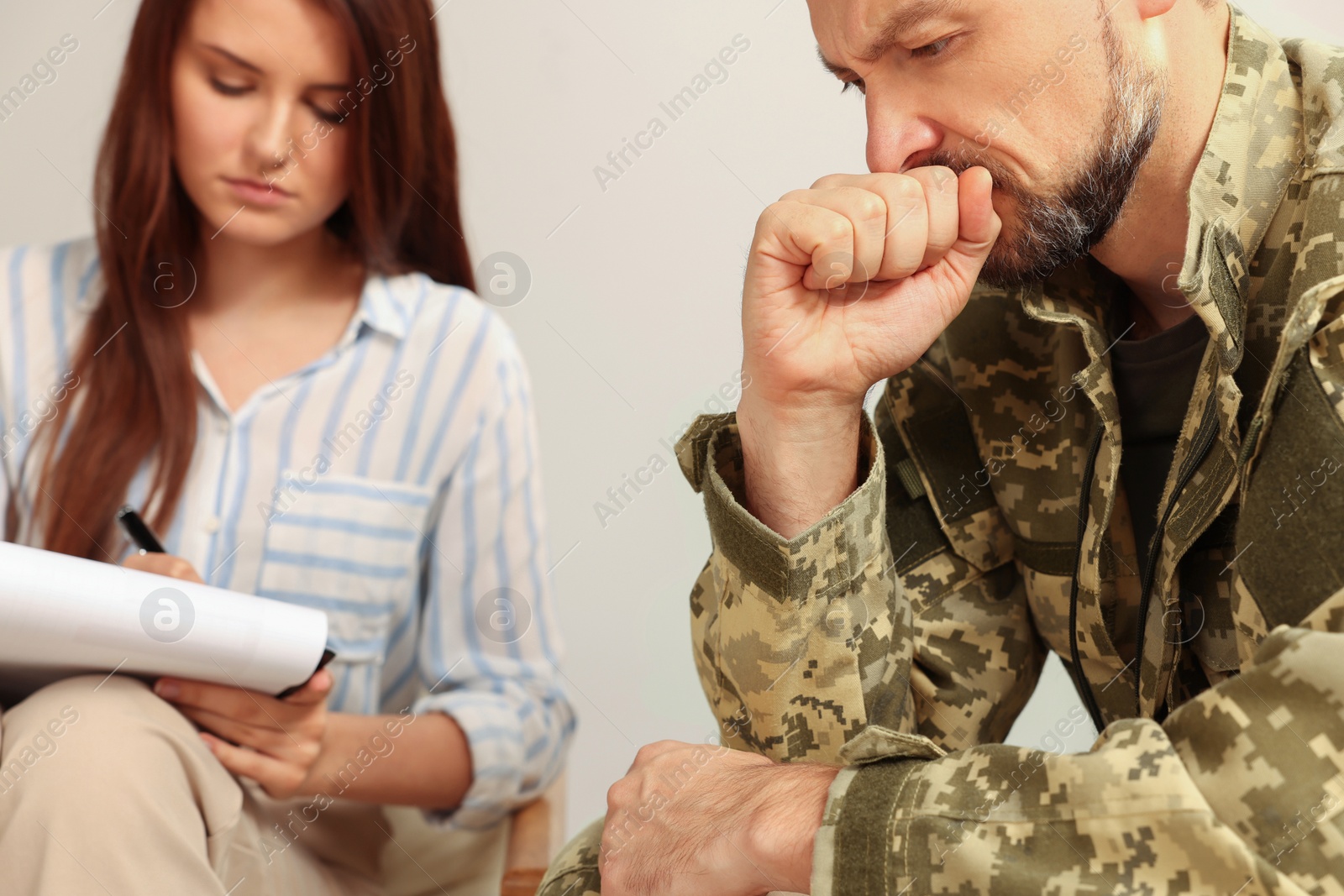 Photo of Psychologist working with military officer in office