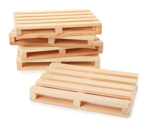Photo of Many small wooden pallets on white background