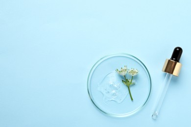 Petri dish with sample of cosmetic oil, pipette and beautiful flowers on light blue background, flat lay. Space for text