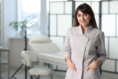 Cosmetologist in medical uniform in clinic, space for text