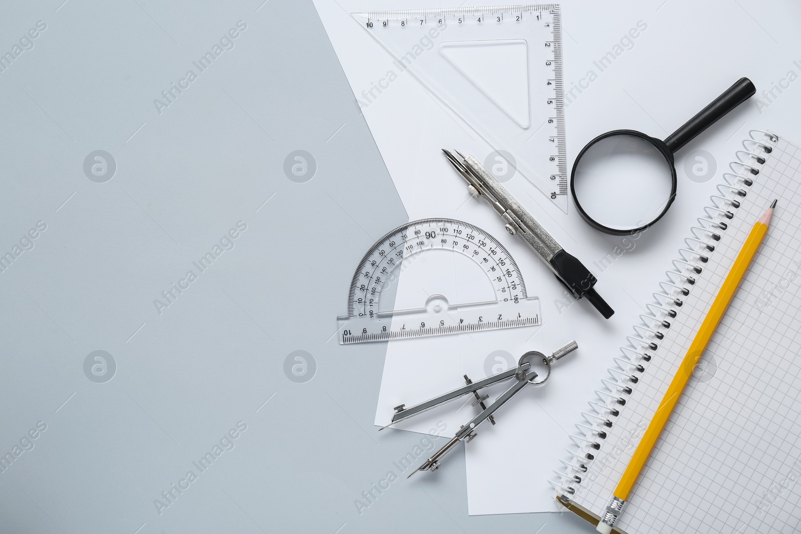 Photo of Different rulers and compasses on light grey background, flat lay. Space for text
