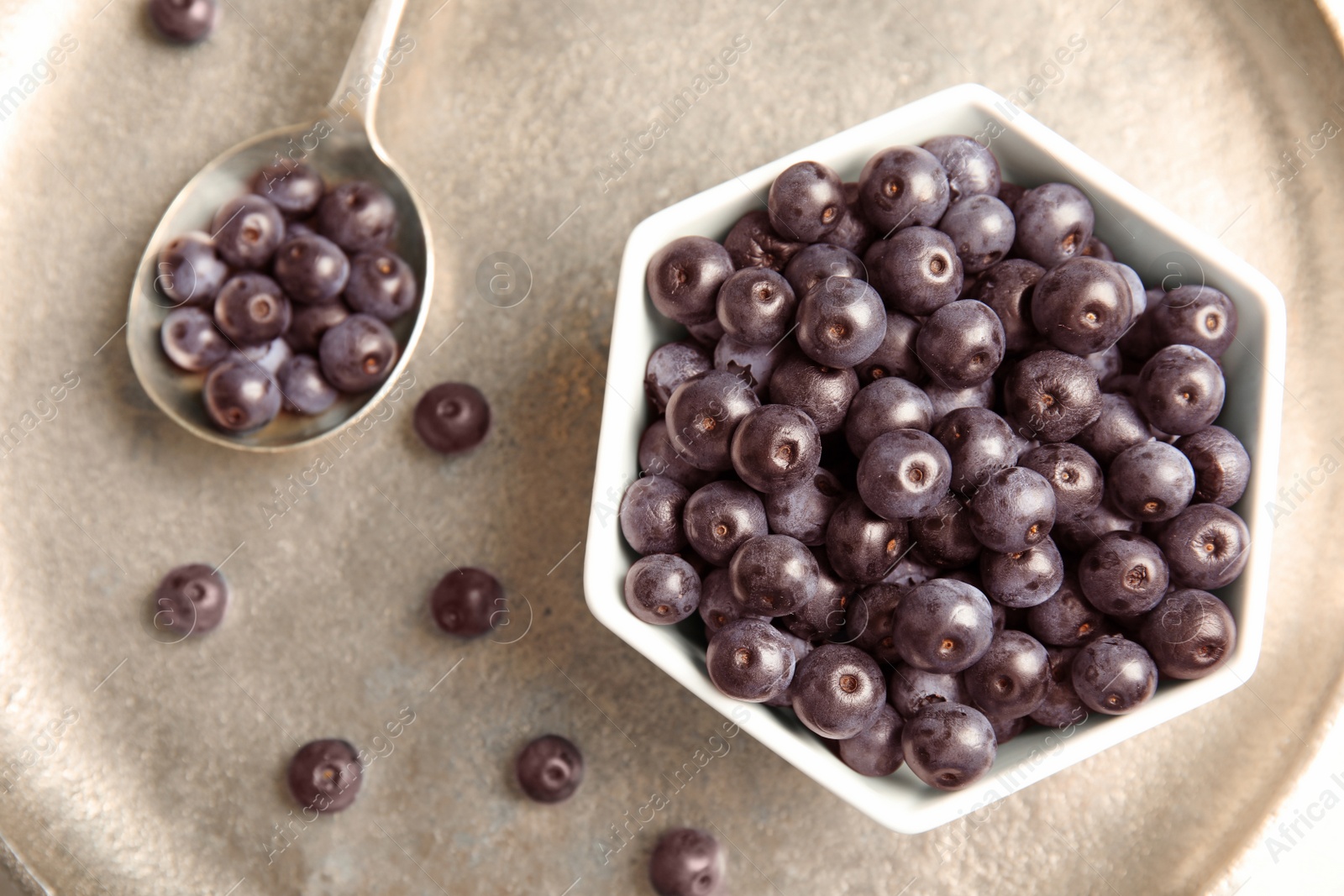 Photo of Bowl with fresh acai berries on tray, top view