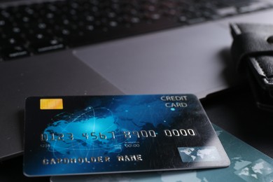 Photo of Credit cards and laptop on grey table, closeup