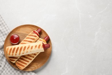 Photo of Delicious french hot dogs and dip sauce on light grey table, top view. Space for text