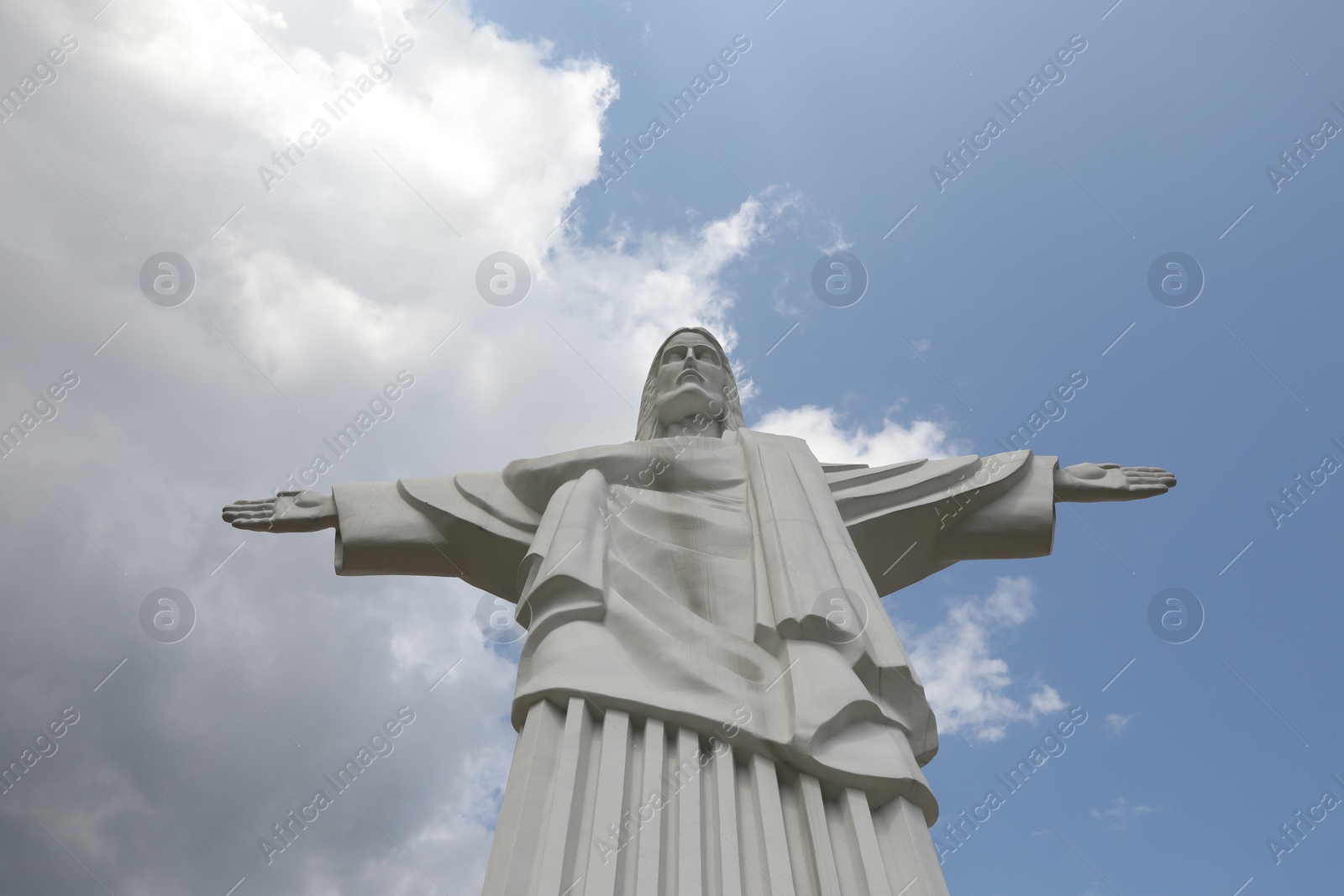 Photo of Truskavets, Ukraine - July 22, 2023: Beautiful statue of Christ the Redeemer against cloudy blue sky, low angle view