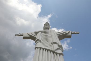 Photo of Truskavets, Ukraine - July 22, 2023: Beautiful statue of Christ the Redeemer against cloudy blue sky, low angle view